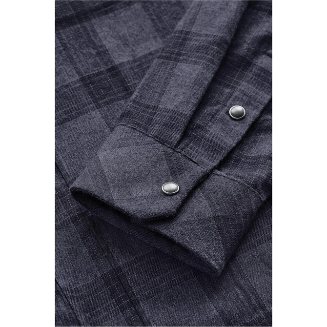A close-up view of a dark grey plaid button-up shirt, featuring snap buttons and a neatly folded cuff.