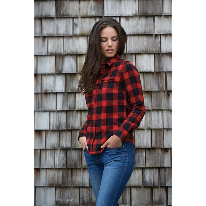 A women's red and black checkered button-up shirt with a snap front, worn by a model against a wooden background.
