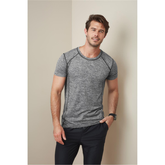 A grey marled men's T-shirt with contrasting seams, featuring a logo on the chest, paired with black trousers.