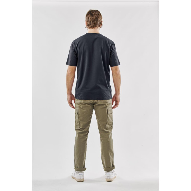 A man is wearing a dark grey T-shirt and khaki cargo pants, viewed from the back. The T-shirt features a logo.