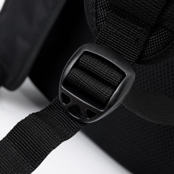 A close-up of a black backpack strap featuring an adjustable buckle and textured fabric.