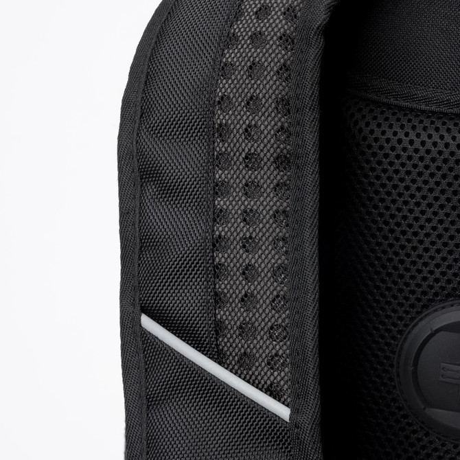 Close-up of a black backpack featuring a textured mesh panel and a circular branding logo.