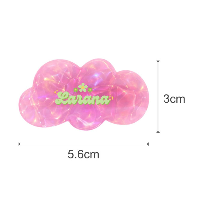 A pink iridescent hair clip shaped like a cloud with a logo, measuring 5.6cm by 3cm.