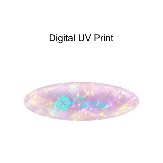 An oval iridescent hair clip with pastel shades and a floral logo. Features a textured surface.
