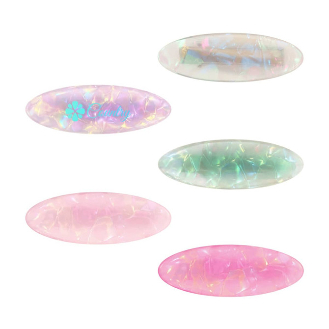 An assortment of oval iridescent alligator hair clips in pink, green, and transparent colours, featuring a logo on one.