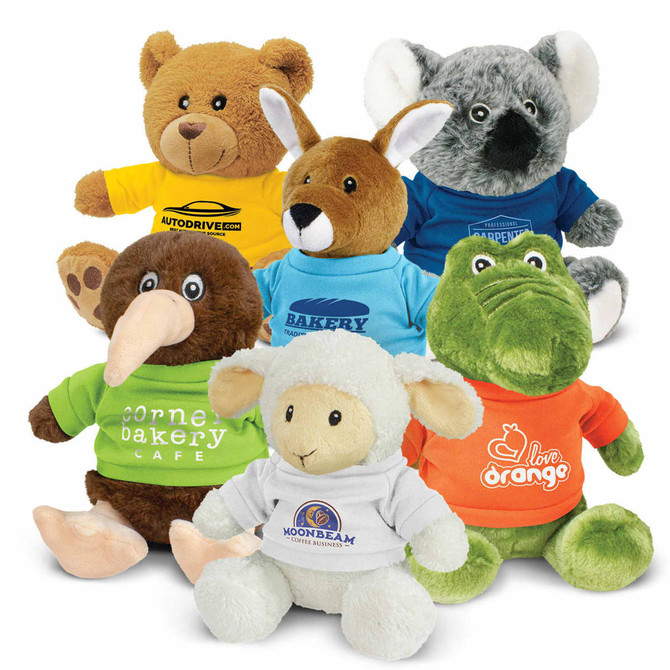 Assorted plush toys in various colours, including a bear, kangaroo, kiwi, sheep, and crocodile, wearing T-shirts.