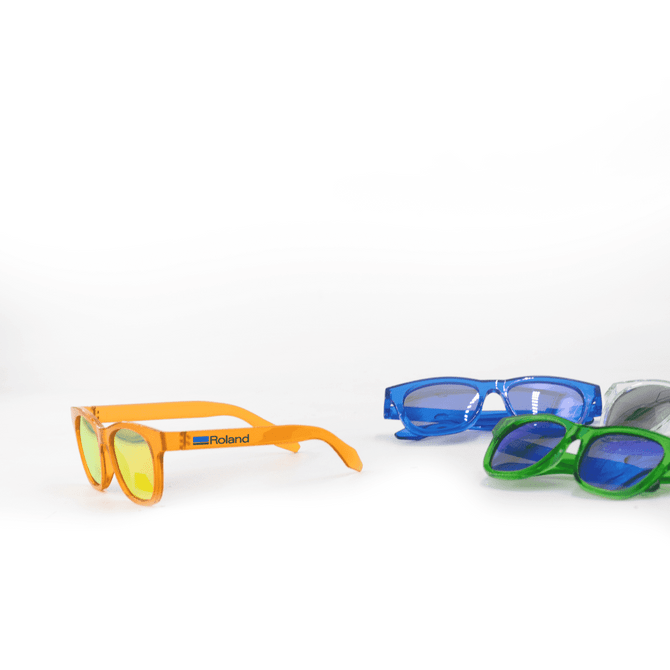 Brightly coloured sunglasses in orange, blue, and green, featuring a logo on one pair.