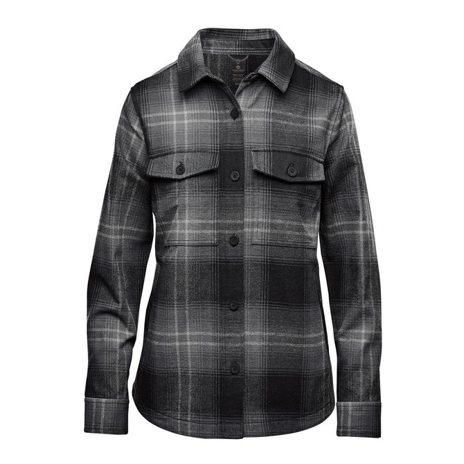A women's shacket in a black and grey highland plaid pattern, featuring a button-up front and two chest pockets.