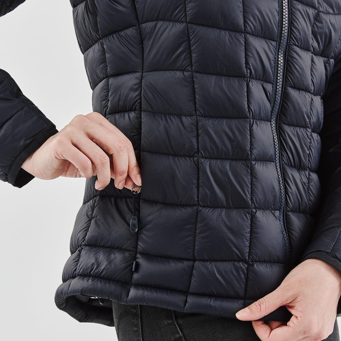 A women's puffer jacket in navy blue, featuring a quilted design and side zipper pockets. Includes branding.