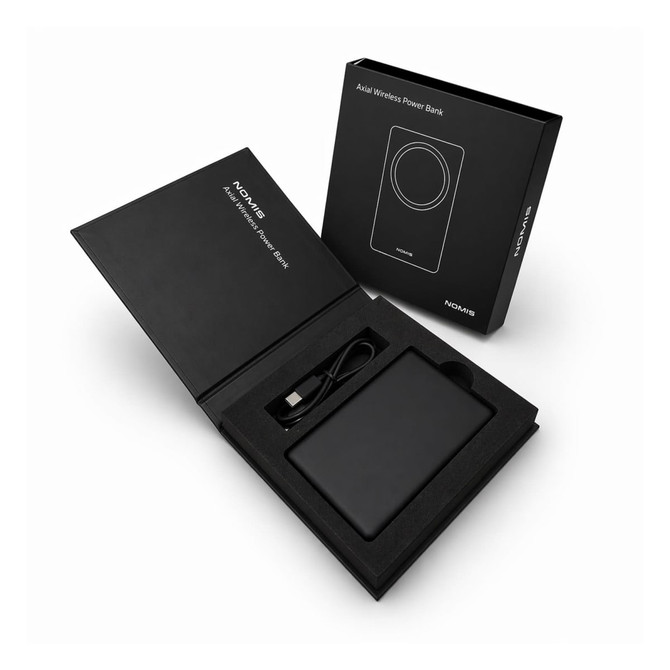 A black wireless power bank in an open box, with a USB cable and branding visible inside.
