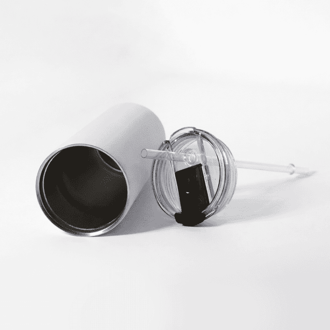 A drink bottle with a silver exterior, a clear lid, and a reusable straw lies on a white surface.