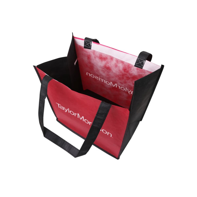 A tall non-woven tote bag featuring red and black colours, with sturdy handles and a logo inside.