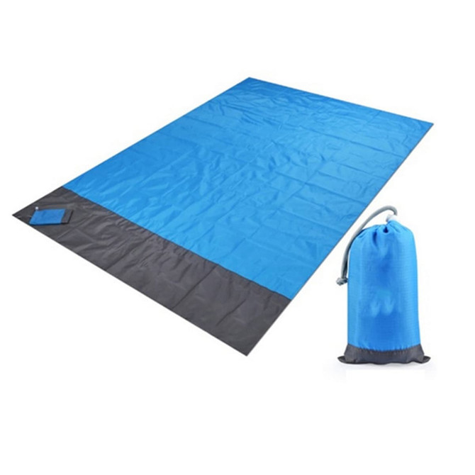 A medium picnic blanket in blue and grey, folded beside a matching pouch for storage.