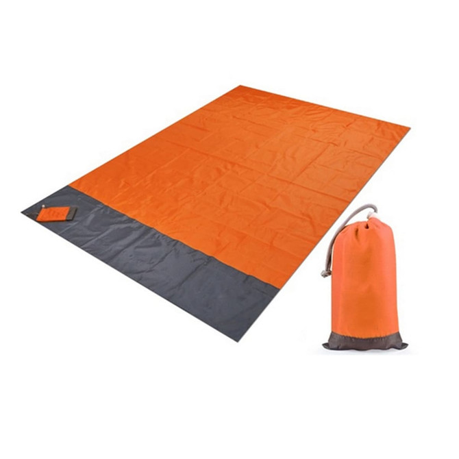 An orange and grey picnic blanket laid out flat next to a matching carry pouch.