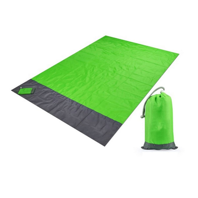 A large picnic blanket in vibrant green with a dark grey edge, accompanied by a matching carry pouch.