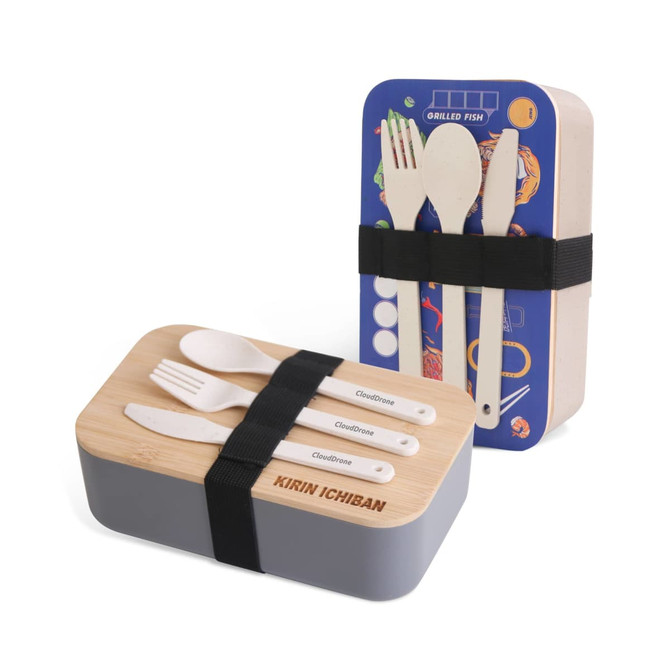 A lunch box featuring a grey base and a bamboo cover, with utensils inside and a branding logo.