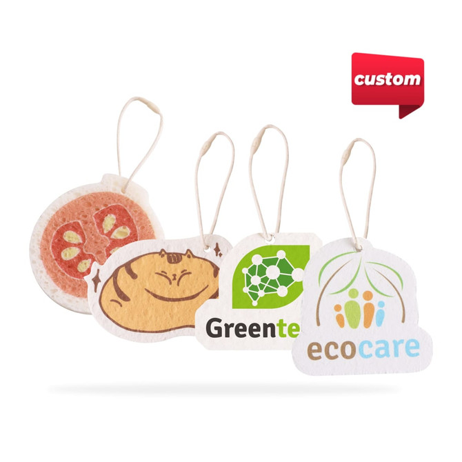 Four custom-shaped air freshener tags in various colours, featuring food and eco-friendly designs, with hanging strings.