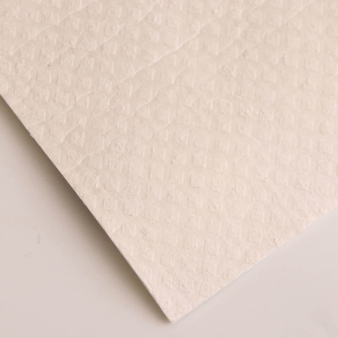 A stack of biodegradable dishwashing cloths in a textured white material.