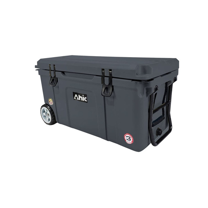 A dark grey cooler box with wheels, featuring a sturdy lid and handles, and including a logo.