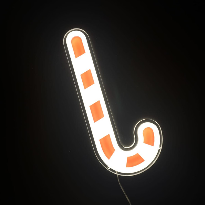 A neon LED sign shaped like a candy cane, featuring red and white stripes against a dark background.
