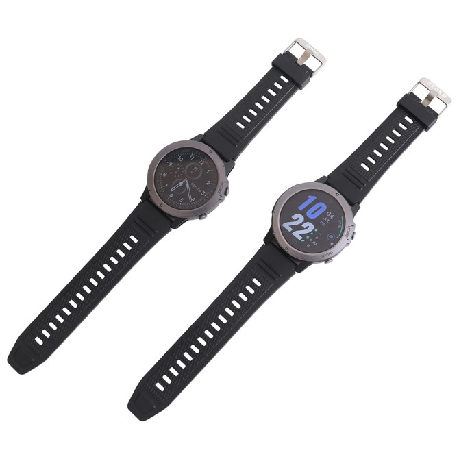 A round smart watch in black with a silver bezel, featuring a digital display and adjustable strap.
