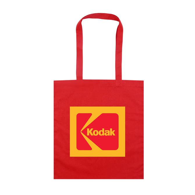 A red tote bag featuring a large yellow square with a logo, including a prominent 'K' design.