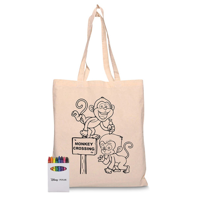 A colourful calico tote bag featuring a monkey design, with a box of crayons beside it. Includes a logo.