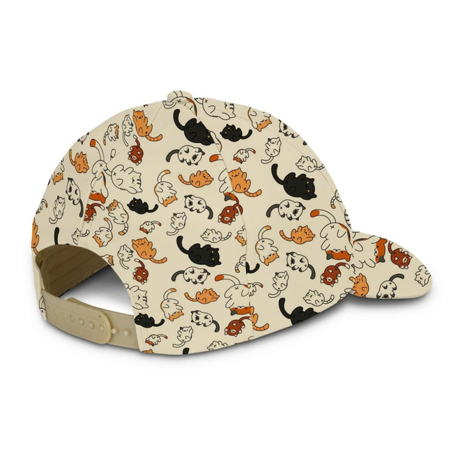 A cap featuring a playful pattern of cats in various colours on a cream background, with an adjustable strap at the back.