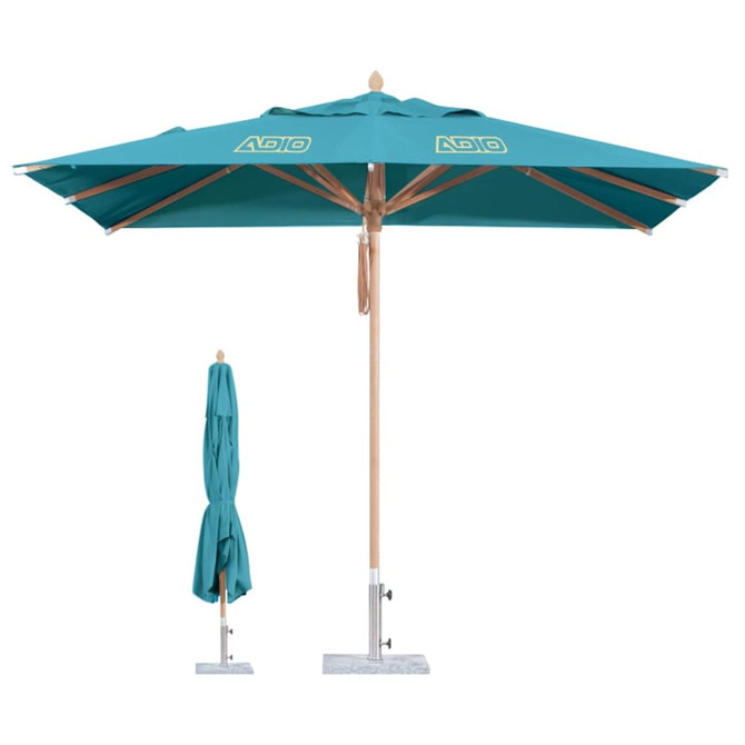 A wind-resistant square outdoor umbrella in teal, featuring a wooden pole and a logo, with a folded version beside it.