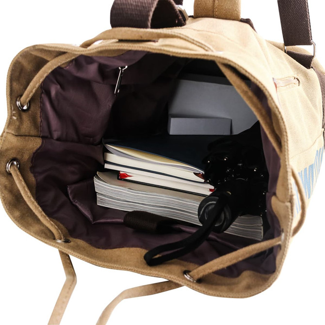 A tan canvas bucket backpack with a dark interior filled with notebooks and a small box. The bag has a logo.