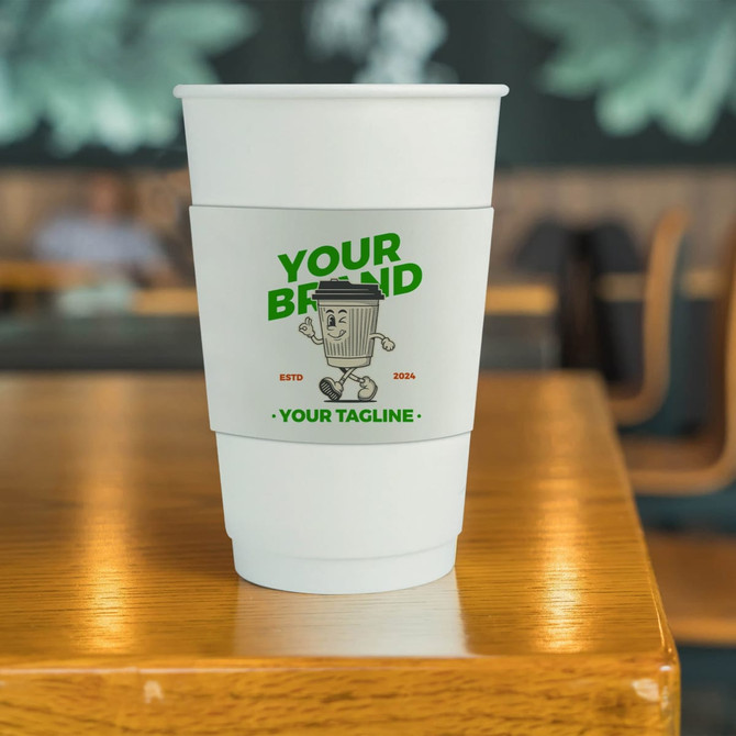 A stack of white PLA double wall compostable paper cups with a colourful sleeve and branding on a wooden table.