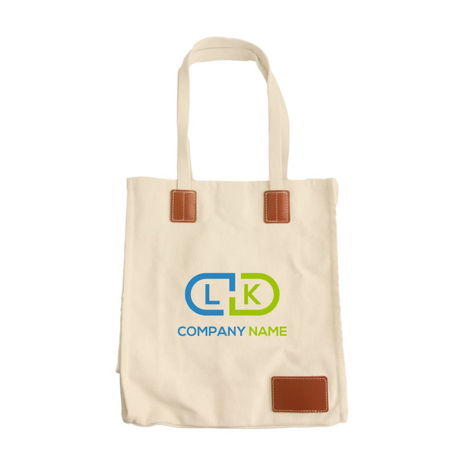 A cream canvas bag with leather accents and a logo, featuring long handles and a magnetic snap closure.