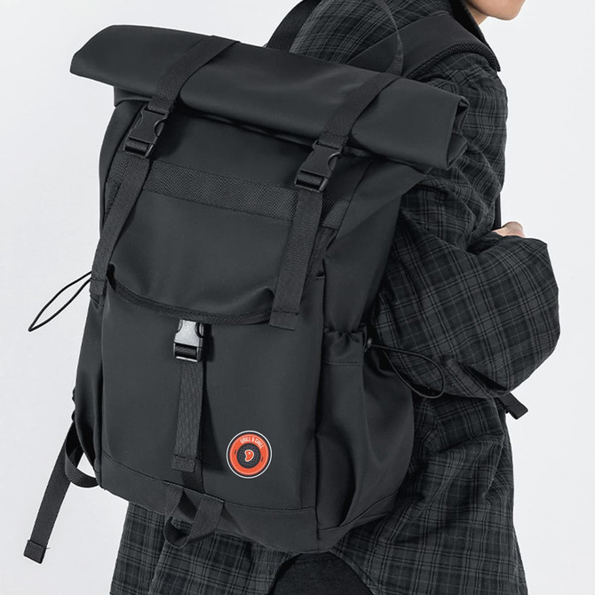 A black polyurethane roll top backpack with adjustable straps and a logo on the front.