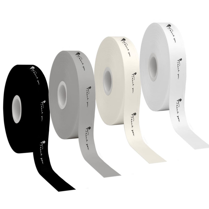 Four rolls of screen printed cotton ribbon in black, grey, white, and cream, featuring logos on each roll.