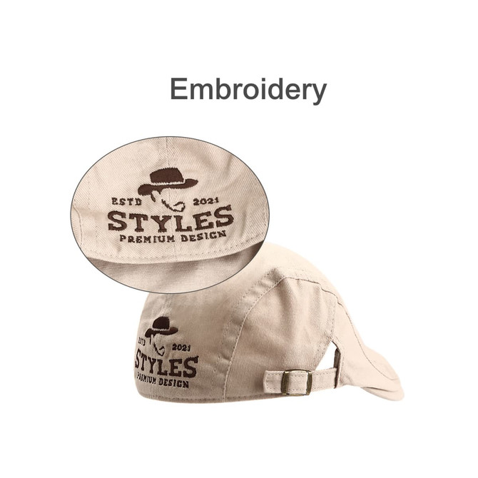 A beige beret hat featuring an embroidered logo and an adjustable strap at the back.