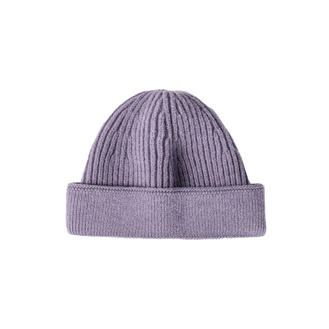 A round beanie in a soft lavender colour, featuring a ribbed texture and a rolled cuff. It has a logo present.
