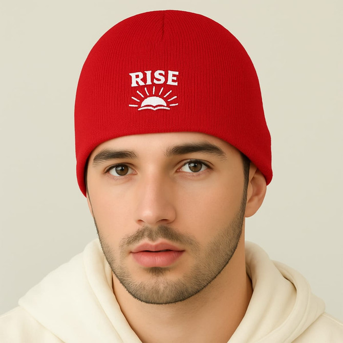 A red beanie with a logo on the front, worn by a person with light skin and dark hair.