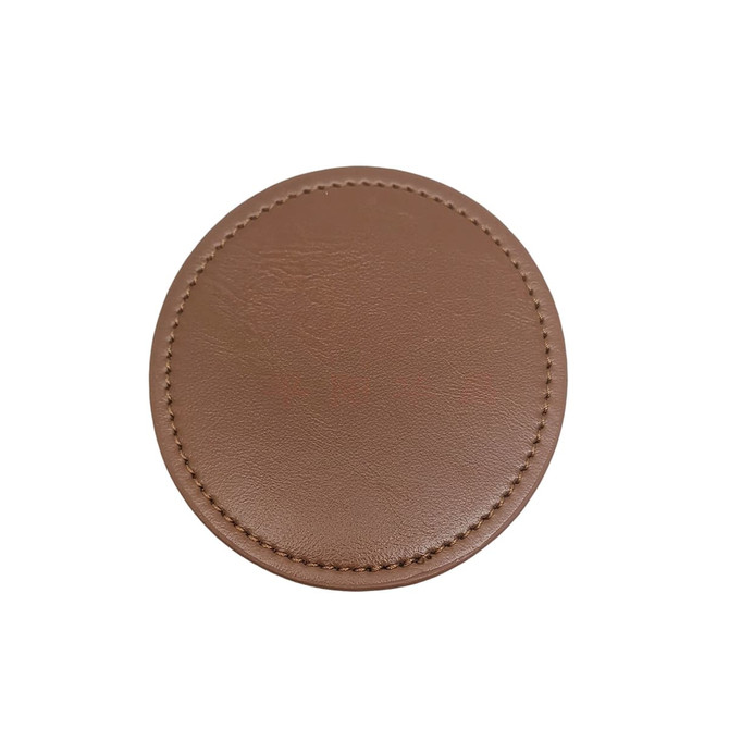 A brown PU coaster with a smooth texture and stitched edges. It features a logo in the centre.
