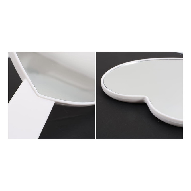 A heart-shaped handheld mirror with a white handle, featuring a smooth reflective surface.