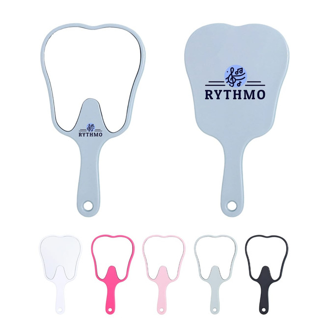 A tooth-shaped face mirror in grey, pink, white, and black, featuring a logo on the back.