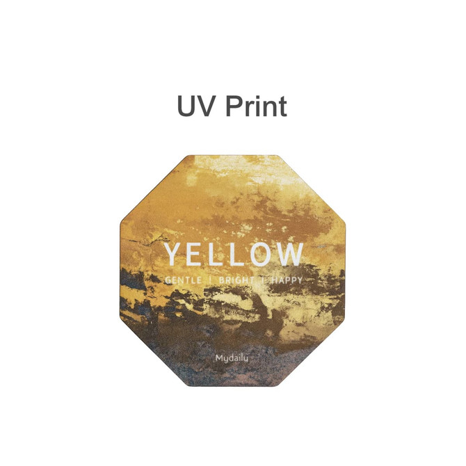 An octagonal frosted metal coaster in shades of yellow with a branded logo. Features a textured, artistic design.