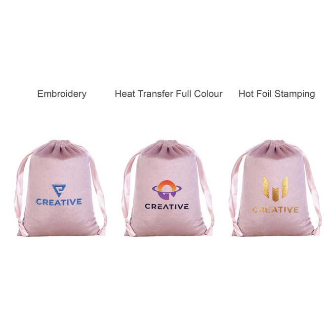 Three pink silk velvet drawstring bags featuring different logos and branding techniques: embroidery, heat transfer, and hot foil stamping.
