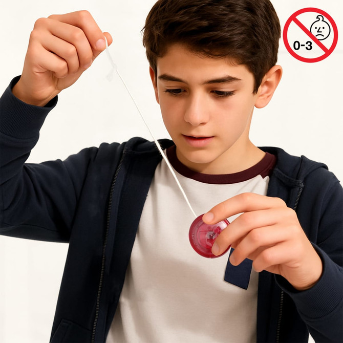 A boy in a navy hoodie holds a red yoyo with a white string, focused on its movement. The image includes a logo.