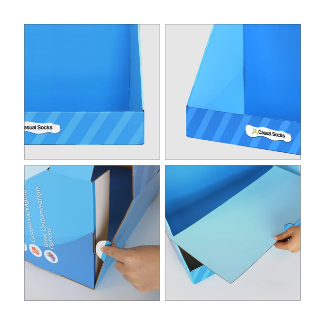 A blue corrugated cardboard display with sections for products, featuring a logo and hand interacting with the box.