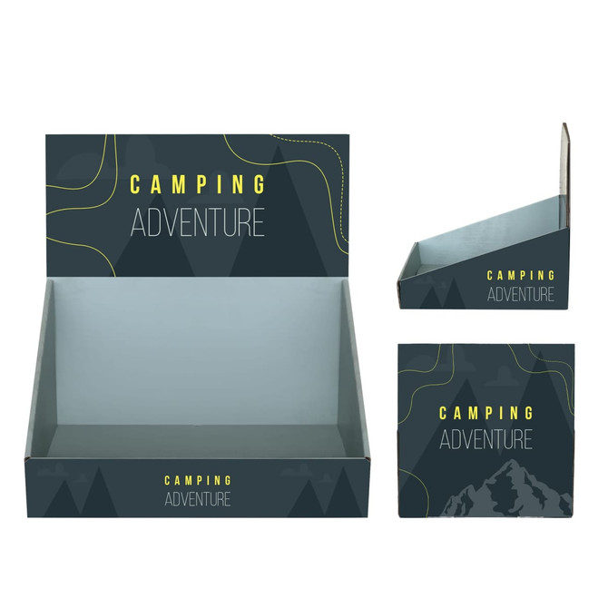 A corrugated cardboard counter display in dark green with a geometric design, featuring the words "Camping Adventure".