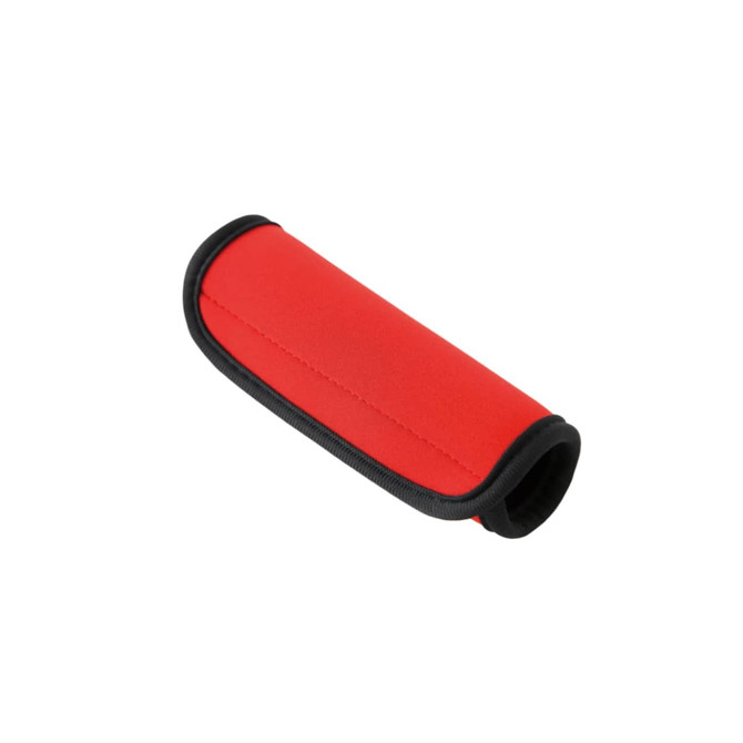A red neoprene luggage grip with black trim, featuring a smooth, cushioned surface and an ergonomic design.