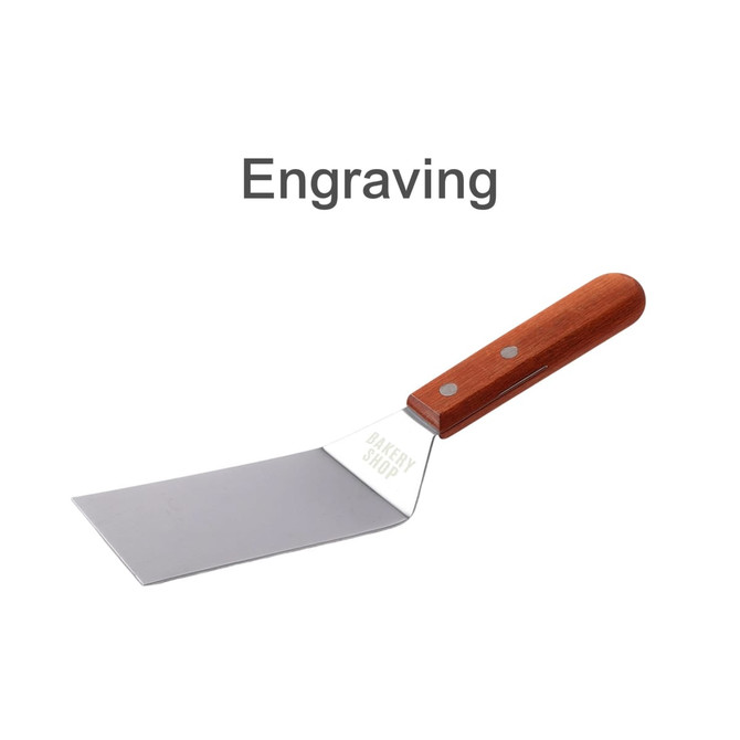 A stainless steel turner with a wooden handle, featuring a branded logo on the blade.