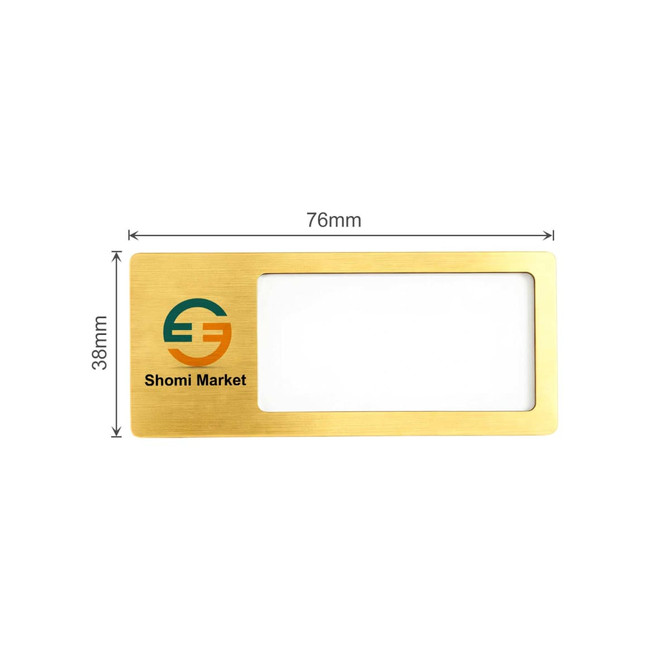 A reusable metal name badge in gold with a clear window and a logo. Dimensions are 76mm by 38mm.