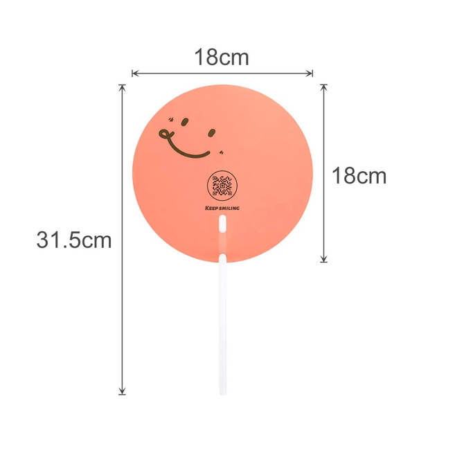 A custom-shaped transparent PVC hand fan in peach with a smiling face design and a white handle. Dimensions are 18cm by 31.5cm.