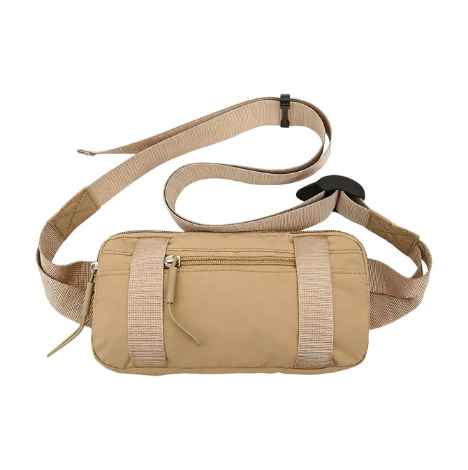 A beige travel fanny pack with a zippered front pocket and an adjustable strap. It features a simple logo.
